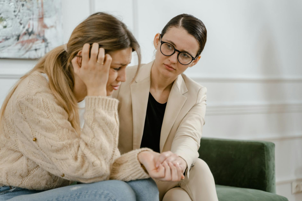 A compassionate counselor talking to a domestic violence witness, representing emotional support services. — witnesses d…