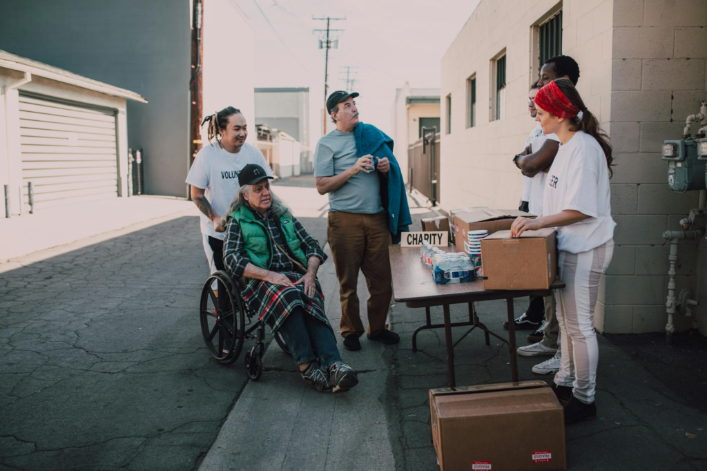 A photo of a local charity event with a focus on genuine giving — types of charity scams