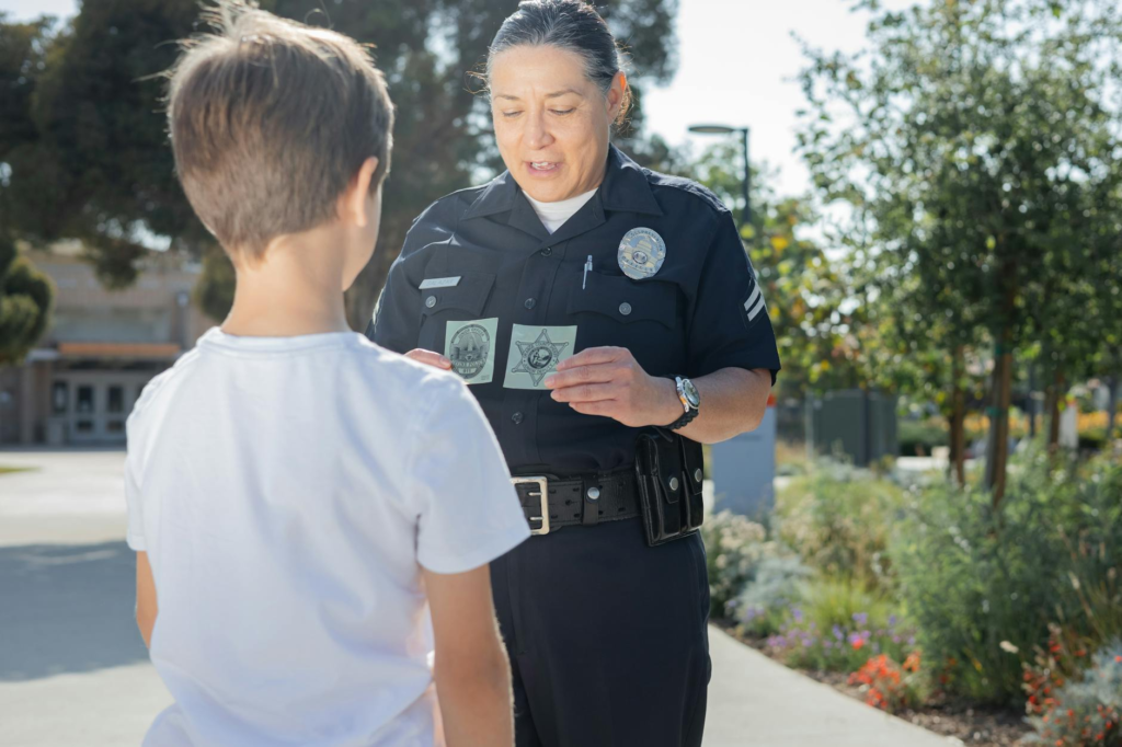 A photo of a police officer receiving a tip from a community member. — submit anonymous tip PA Crime Stoppers