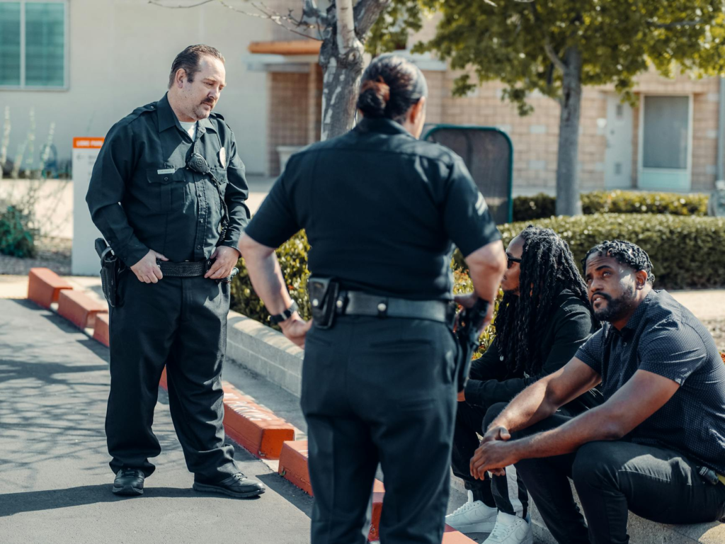 A police officer interacting positively with community members in a neighborhood. — community safety witness Pennsylvania