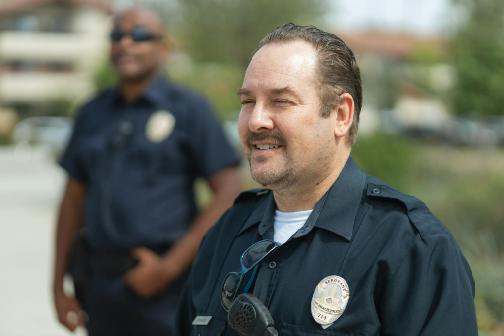 A police officer and a Crime Stoppers volunteer collaborating on a community outreach program. — get involved PA Crime S…