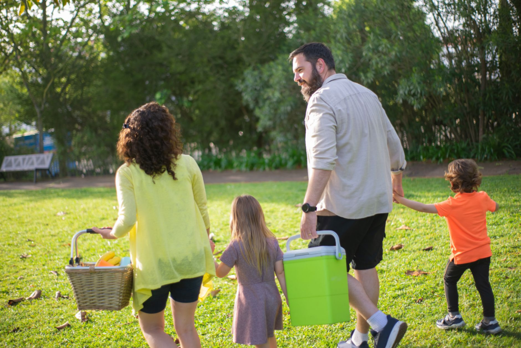 A family enjoying a picnic in a Pennsylvania park, showcasing outdoor safety. — summer safety tips Pennsylvania