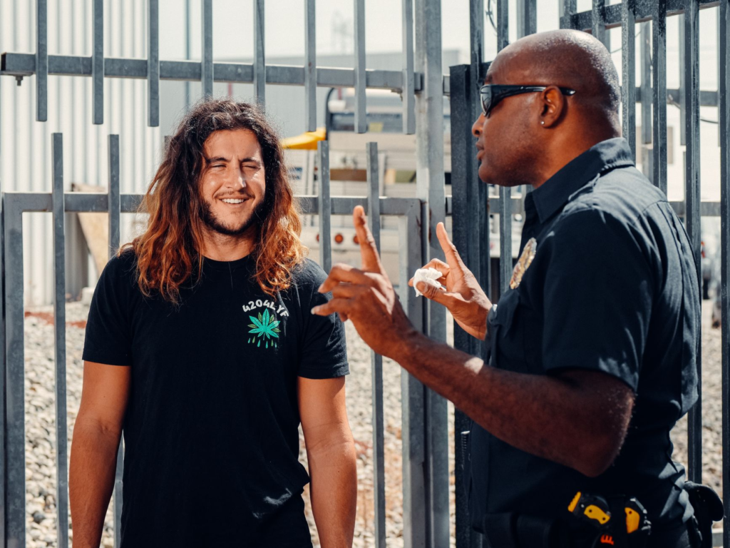 A smiling volunteer talking with local law enforcement officers at a community gathering. — get involved with PA Crime S…