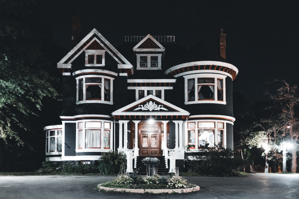 A well-lit home exterior during the evening. — crime prevention tips
