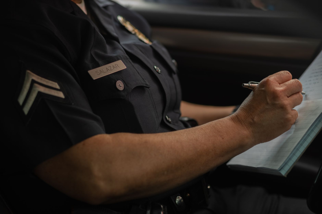 An image of a law enforcement officer taking a tip related to how to submit a tip to PA Crime Stoppers