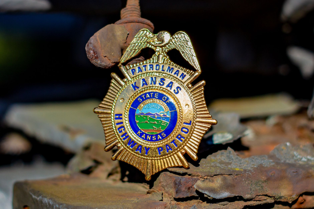 Image of the Pennsylvania state police badge with a backdrop of the state outline. — most wanted fugitives Pennsylvania