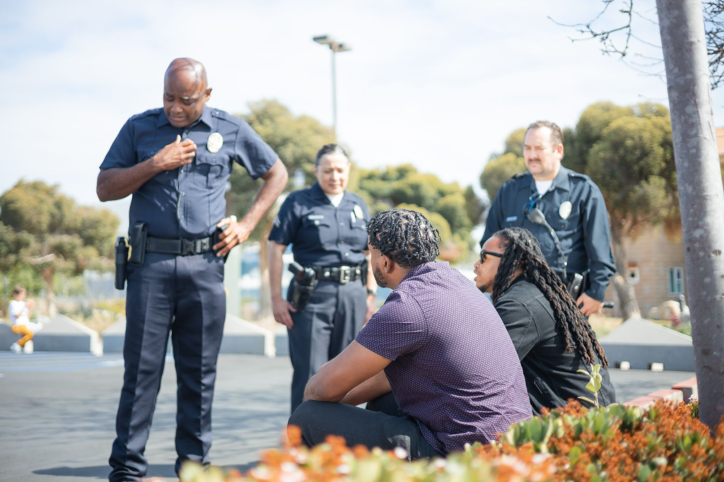 A photo of police officers receiving tips in a community setting. — anonymous tips Pennsylvania