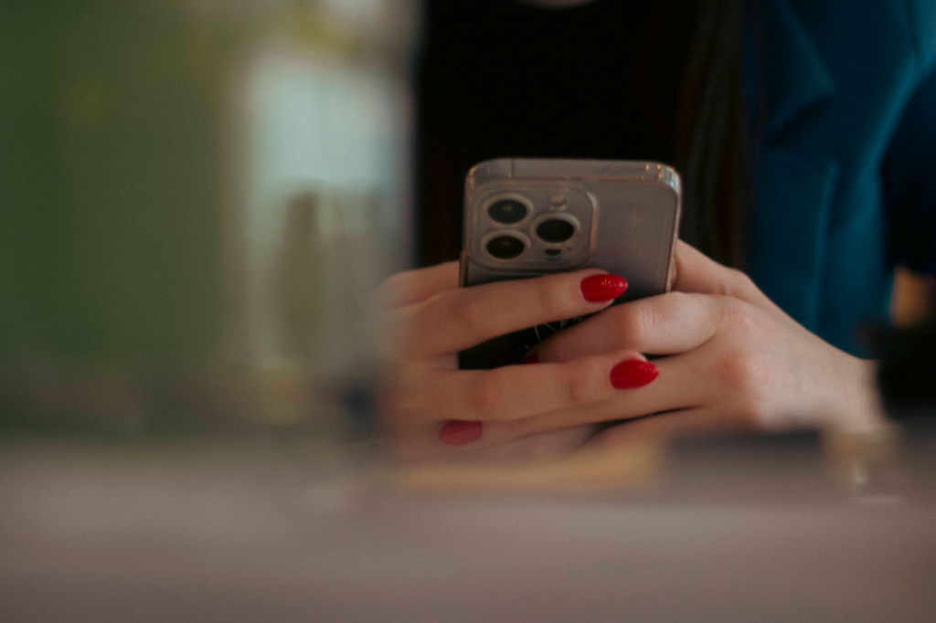 Image depicting a person on a phone submitting a tip to submit tip PA Crime Stoppers
